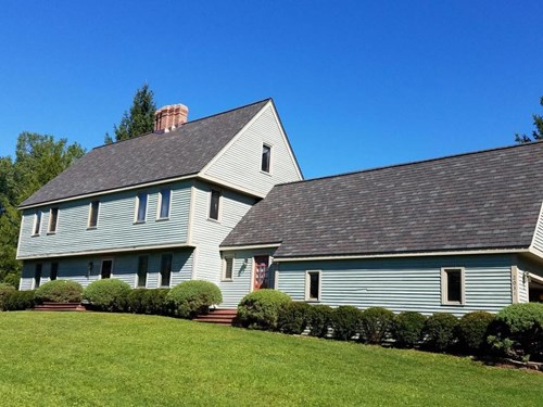 roofing contractors near syracuse ny image of house with replacement shingles from van derhoof