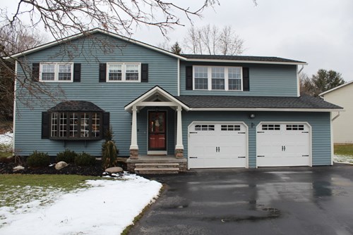 roof leak repair near syracuse ny image of house with snow on lawn from van derhoof roofing